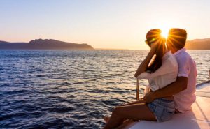 Romantic couple on yacht at sunset in Greece