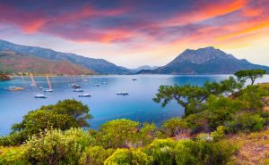 Picturesque Mediterranean seascape in Turkey. Colorful spring sunrise in Adrasan bay with view of Moses Mountain. District of Kemer, Antalya Province. Artistic style post processed photo.