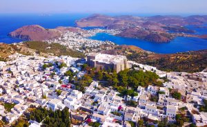 Aerial bird's eye view photo taken by drone of Massive fortified stone Monastery of Saint John the Apostle, Patmos island, Greece